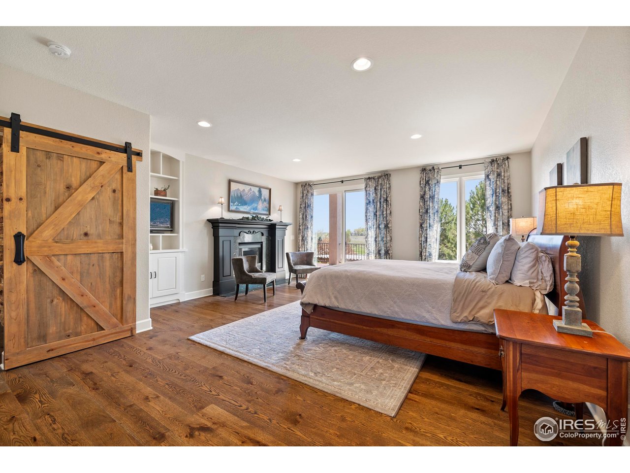 793 Richards Lake Road Fort Collins, CO 80524 - Photo 19 of 40 a bedroom with a bed and wooden floor