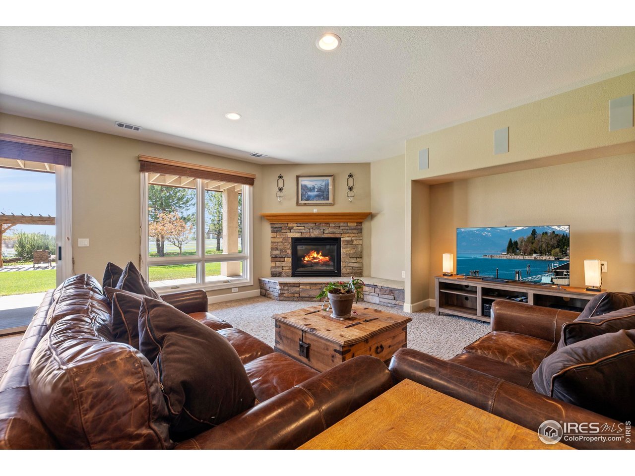 793 Richards Lake Road Fort Collins, CO 80524 - Photo 27 of 40 a living room with furniture a flat screen tv and a fireplace
