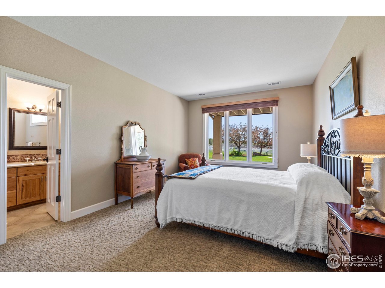 793 Richards Lake Road Fort Collins, CO 80524 - Photo 32 of 40 a bedroom with a bed and a large window