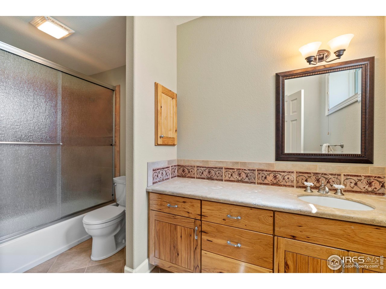 793 Richards Lake Road Fort Collins, CO 80524 - Photo 33 of 40 a bathroom with a sink a toilet and shower