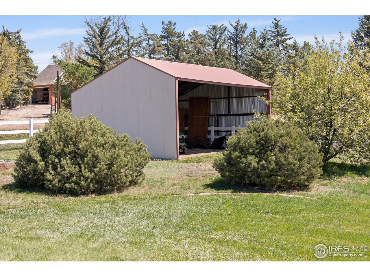 793 Richards Lake Road Fort Collins, CO 80524 - Photo 38 of 40 a view of a house with a yard and garage