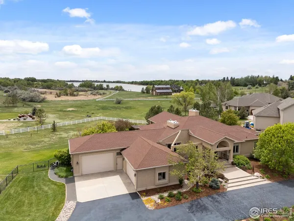 an aerial view of residential houses with outdoor space and ocean view