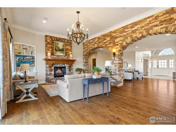 a view of a dining room with furniture a chandelier and wooden floor