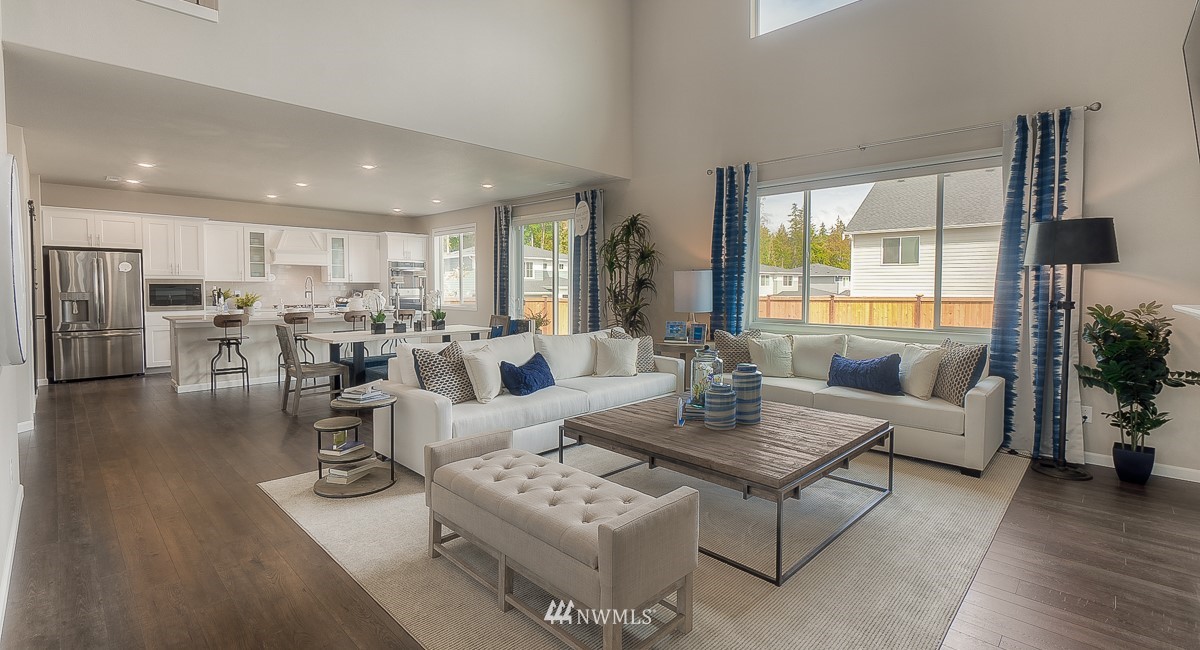 4119 235th Place Southeast, Unit 37 Bothell, WA 98021 - Photo 10 of 23 a living room with lots of furniture and a large window