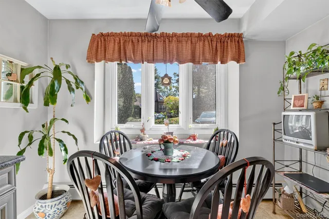 a view of a dining room with furniture and window