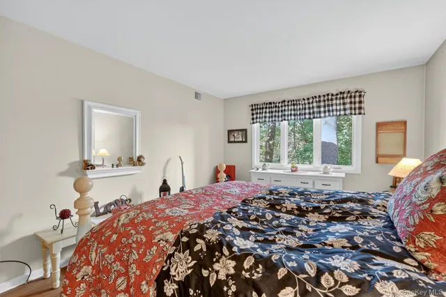 a bed sitting in a bedroom next to a window