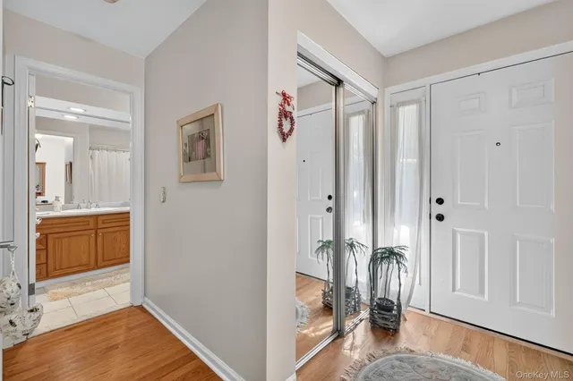 a view of a bedroom with a bed and wooden floor