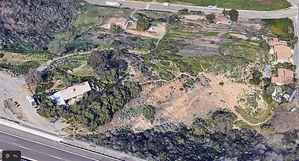 a aerial view of a house with a yard and plants