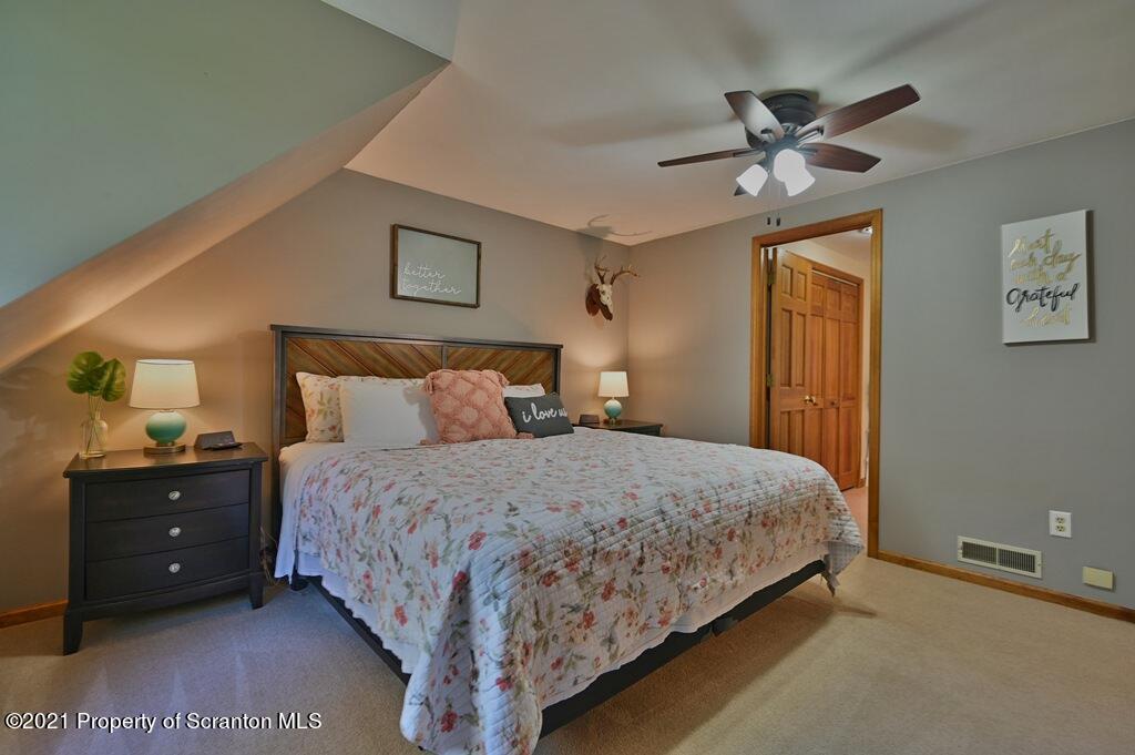 113 Marcy Road Tunkhannock, PA 18657 - Photo 36 of 82 a bedroom with a bed and a lamp on dresser