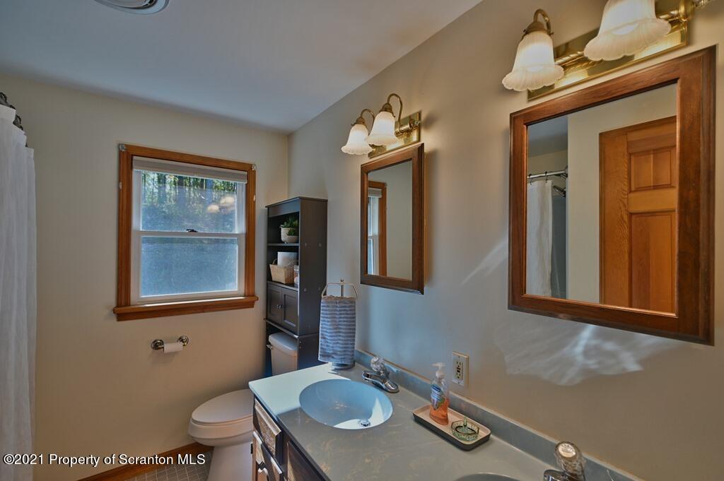 113 Marcy Road Tunkhannock, PA 18657 - Photo 54 of 82 a bathroom with a granite countertop sink mirror vanity and toilet