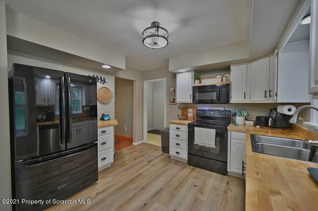 113 Marcy Road Tunkhannock, PA 18657 - Photo 6 of 82 a kitchen with stainless steel appliances and wooden floor