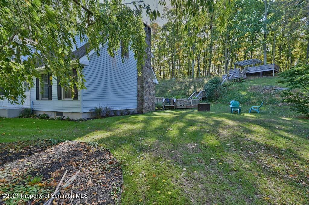 113 Marcy Road Tunkhannock, PA 18657 - Photo 66 of 82 a view of a backyard with table and chairs and wooden fence
