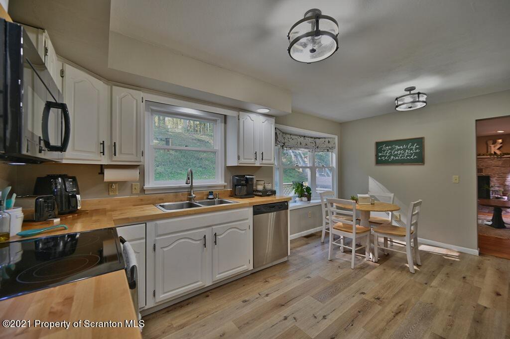 113 Marcy Road Tunkhannock, PA 18657 - Photo 10 of 82 a kitchen with stainless steel appliances granite countertop a stove top oven a sink dishwasher and white cabinets with wooden floor