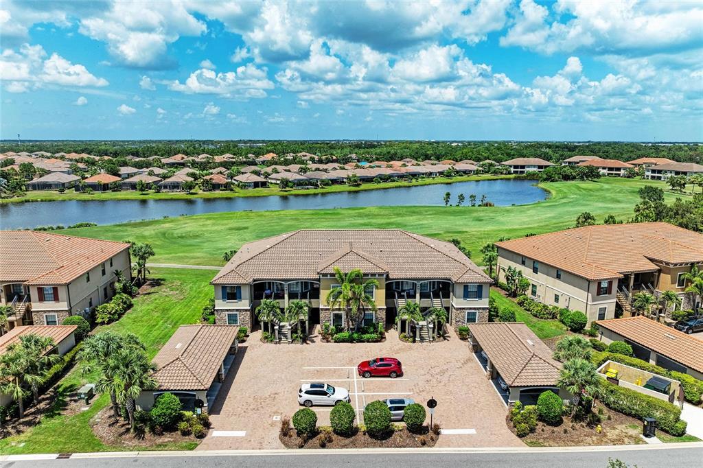 13609 Messina Loop, Unit 104 Bradenton, FL 34211 - Photo 1 of 1 an aerial view of a house with garden space and outdoor seating