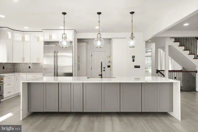 a view of a hallway with wooden floor and entryway