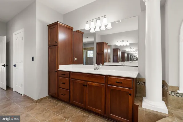 a front view of a house with yard and parking