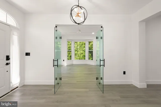 a view of entryway and hall with wooden floor