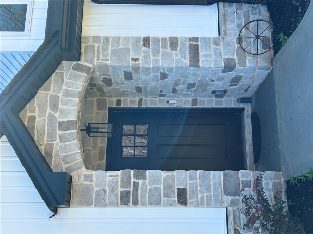 119 Dobbins Road Townville, SC 29689 - Photo 17 of 21 This charming home features a welcoming entrance with elegant stonework and a classic black door.