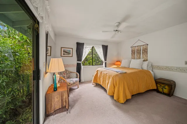 a bedroom with a bed and a painting on the wall