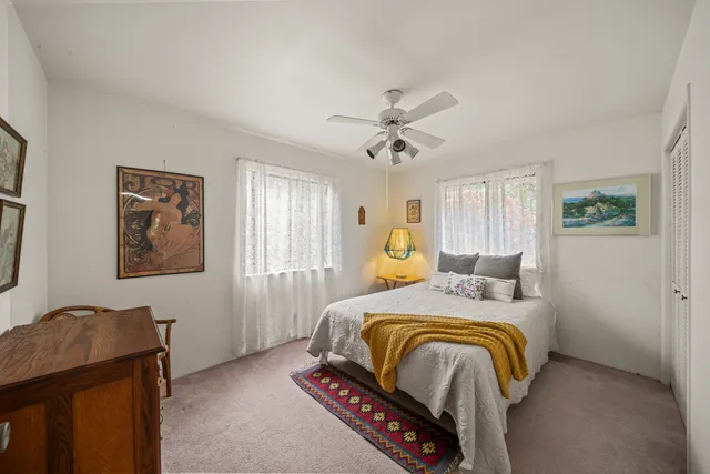 a bedroom with a bed and dresser