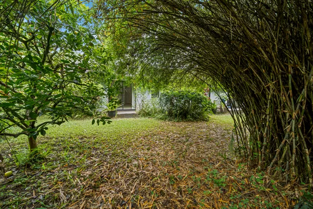 a front view of a house with porch and garden