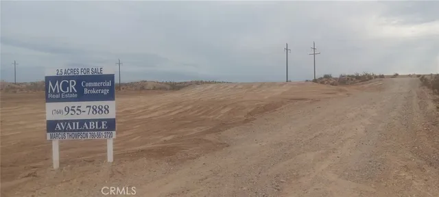a street sign on a wall next to a road