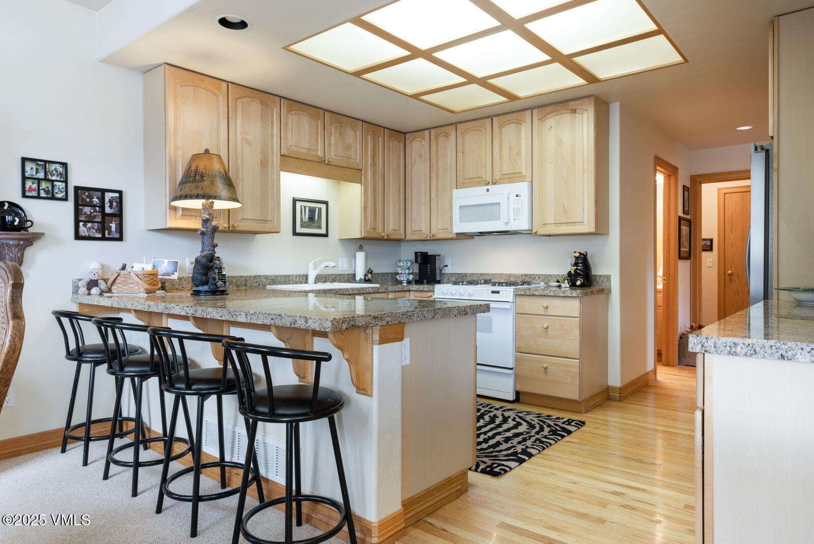 840 June Creek Road Edwards, CO 81632 - Photo 13 of 34 a kitchen with granite countertop white cabinets and stainless steel appliances