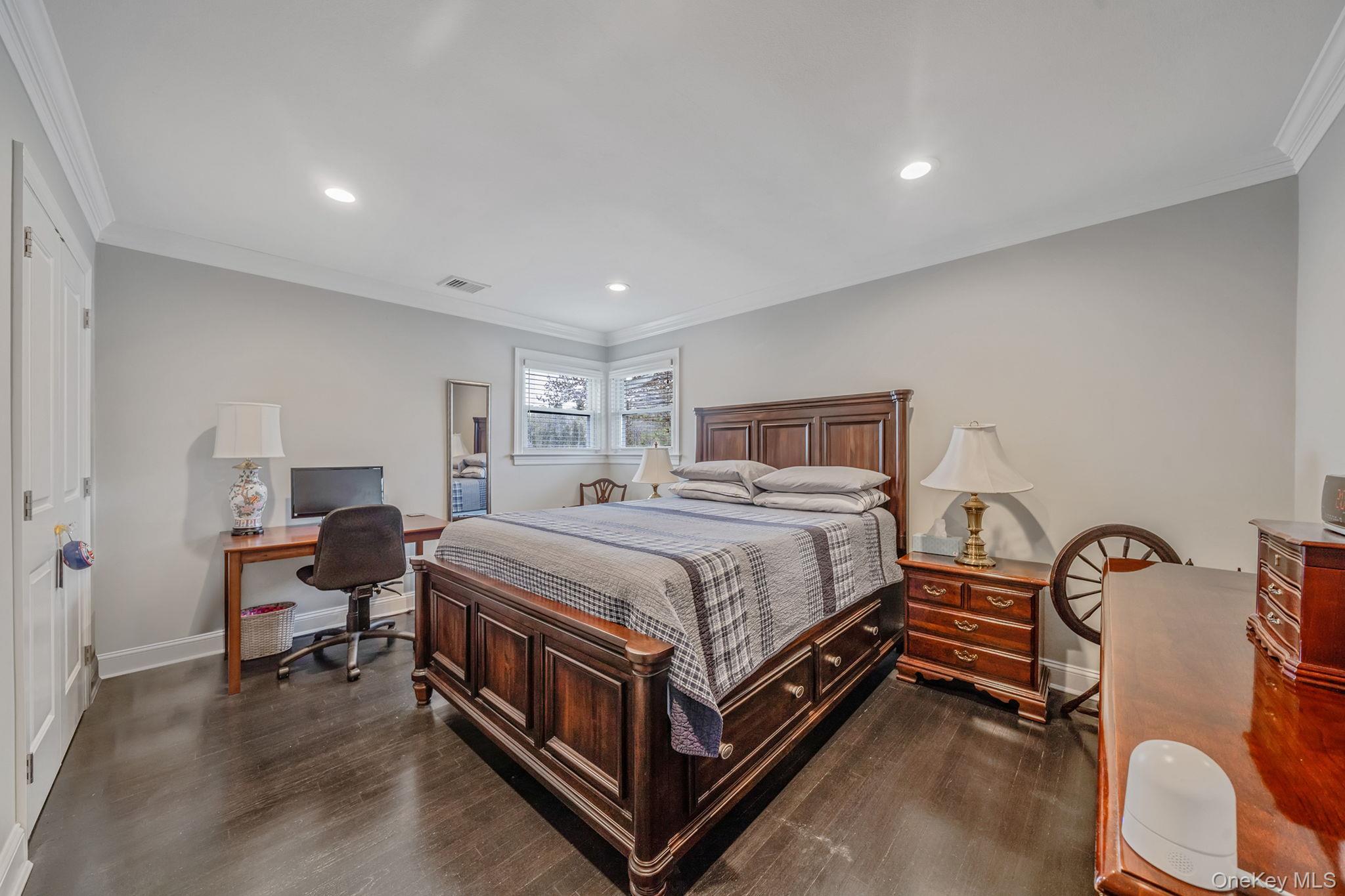 110 Stephen Road Bayport, NY 11705 - Photo 22 of 39 a bedroom with a bed and a lamp