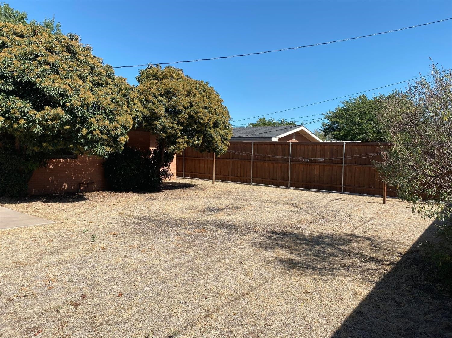 4819 44th Street Lubbock, TX 79414 - Photo 14 of 14 a view of wooden fence and a yard
