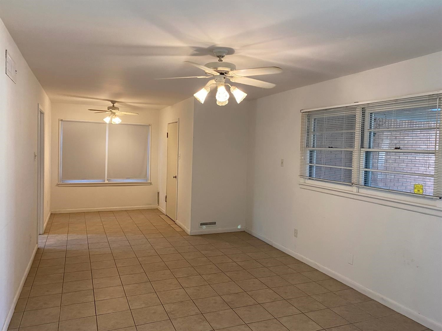 4819 44th Street Lubbock, TX 79414 - Photo 3 of 14 a view of an empty room with window and chandelier fan