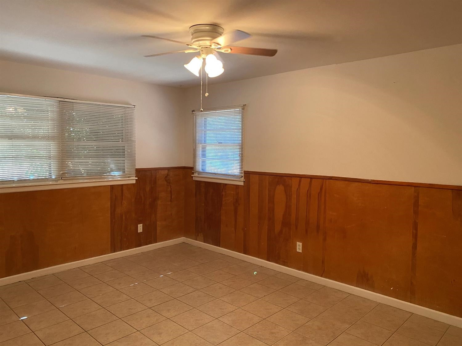 4819 44th Street Lubbock, TX 79414 - Photo 7 of 14 an empty room with windows and fan