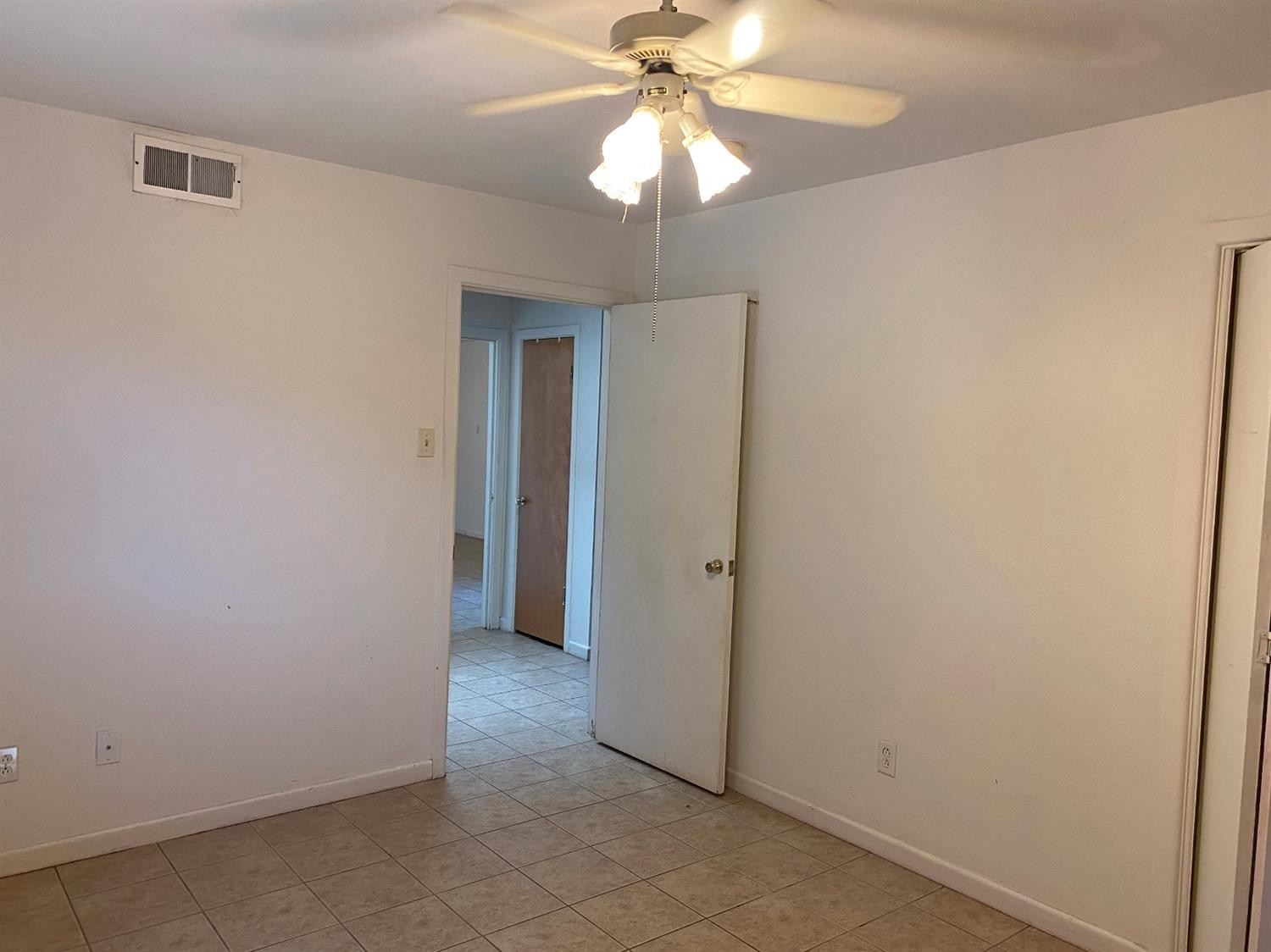 4819 44th Street Lubbock, TX 79414 - Photo 9 of 14 an empty room with a chandelier fan and closet area