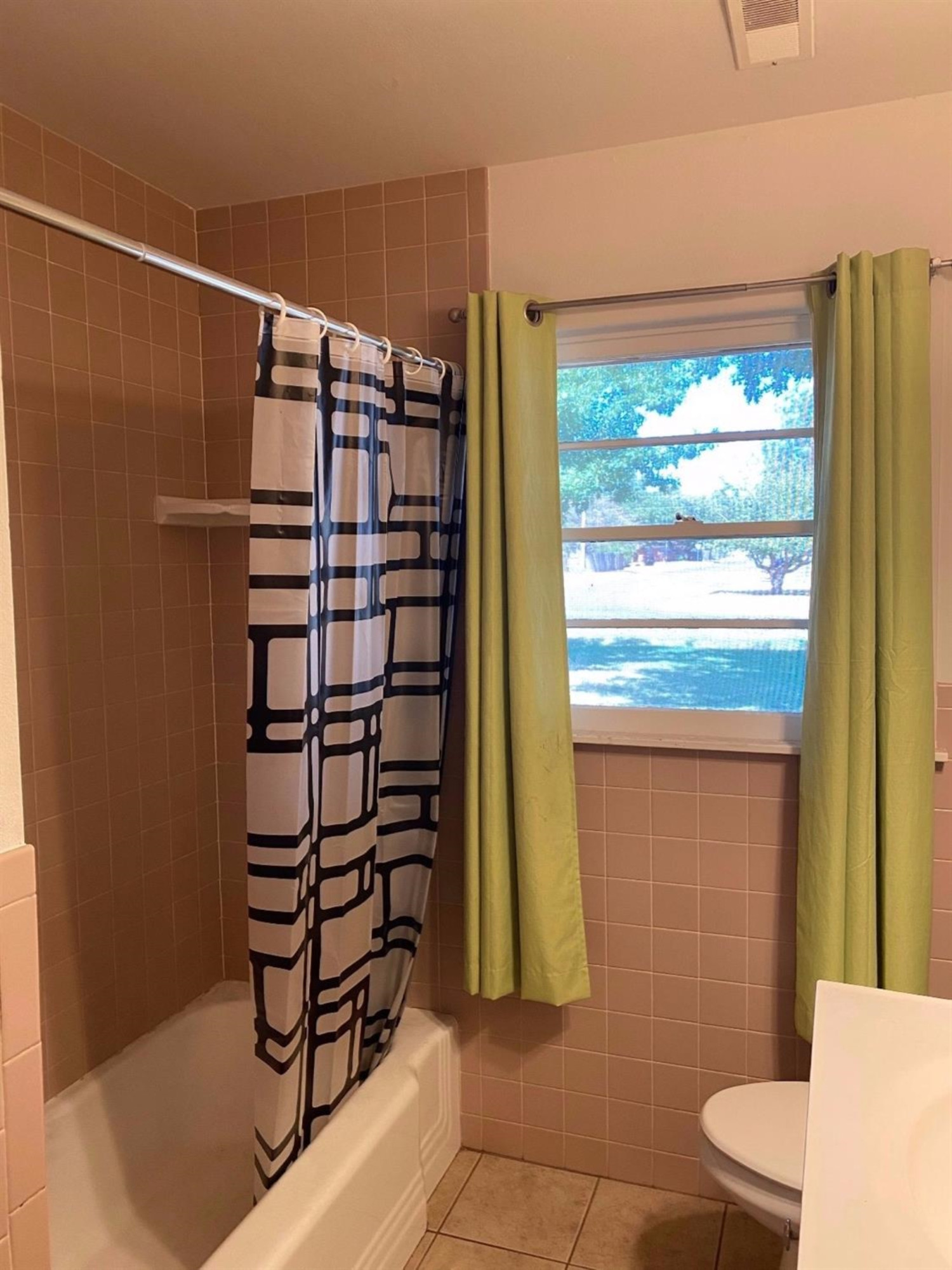 4819 44th Street Lubbock, TX 79414 - Photo 10 of 14 a bathroom with a shower toilet and sink