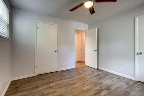 a view of an empty room and window chandelier fan