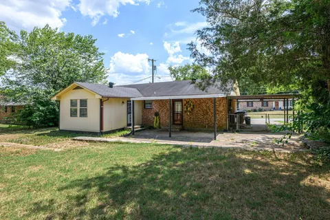 a house view with a sitting space and garden
