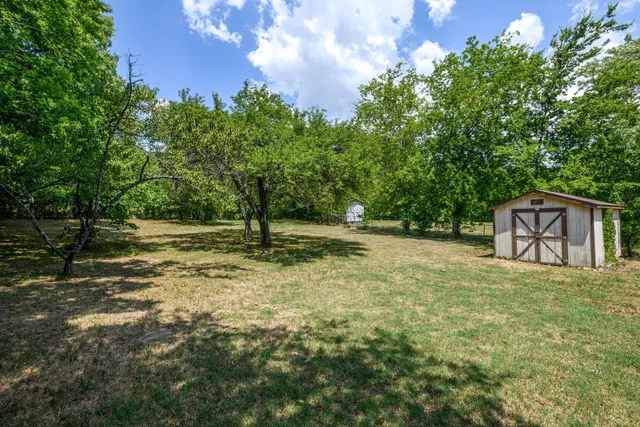 a backyard of a house with lots of green space