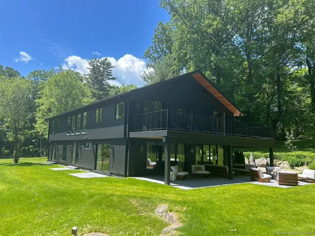 a front view of a house with a yard table and chairs