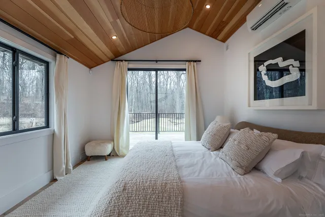 a bedroom with a large bed and a window