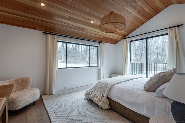 a bedroom with a bed couch and window