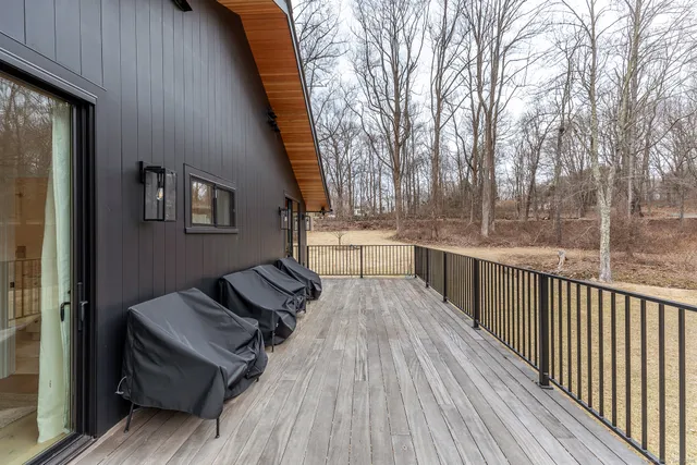 a view of a balcony with wooden floor and fence