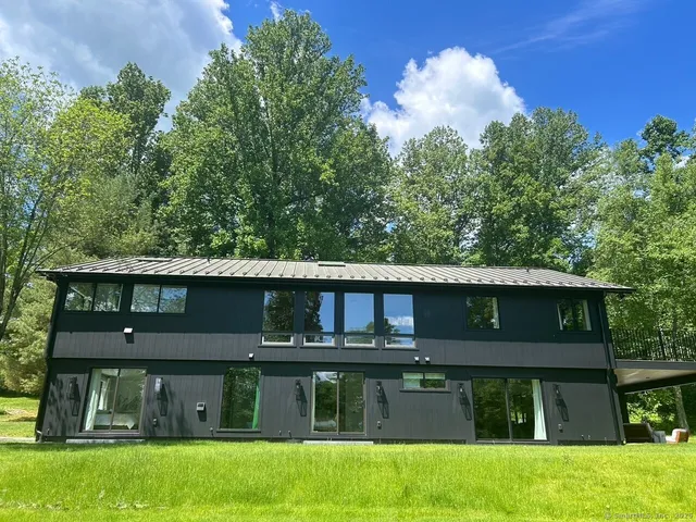 a view of a house with a yard in front of it