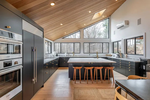 a kitchen with stainless steel appliances granite countertop a stove a sink and a refrigerator