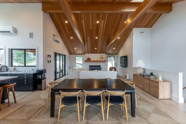 a dining room with furniture window and wooden floor