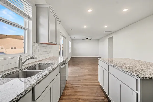 a kitchen with a sink stove and cabinets