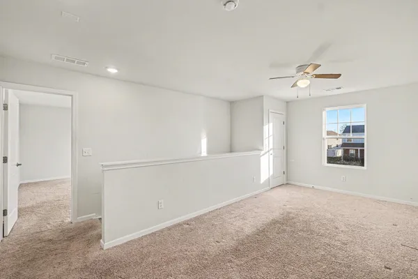 a view of a livingroom with a ceiling fan window and a ceiling fan