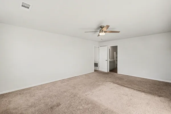 a view of a room with cabinet and ceiling fan
