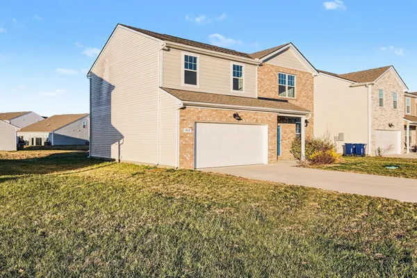 a front view of a house with a yard
