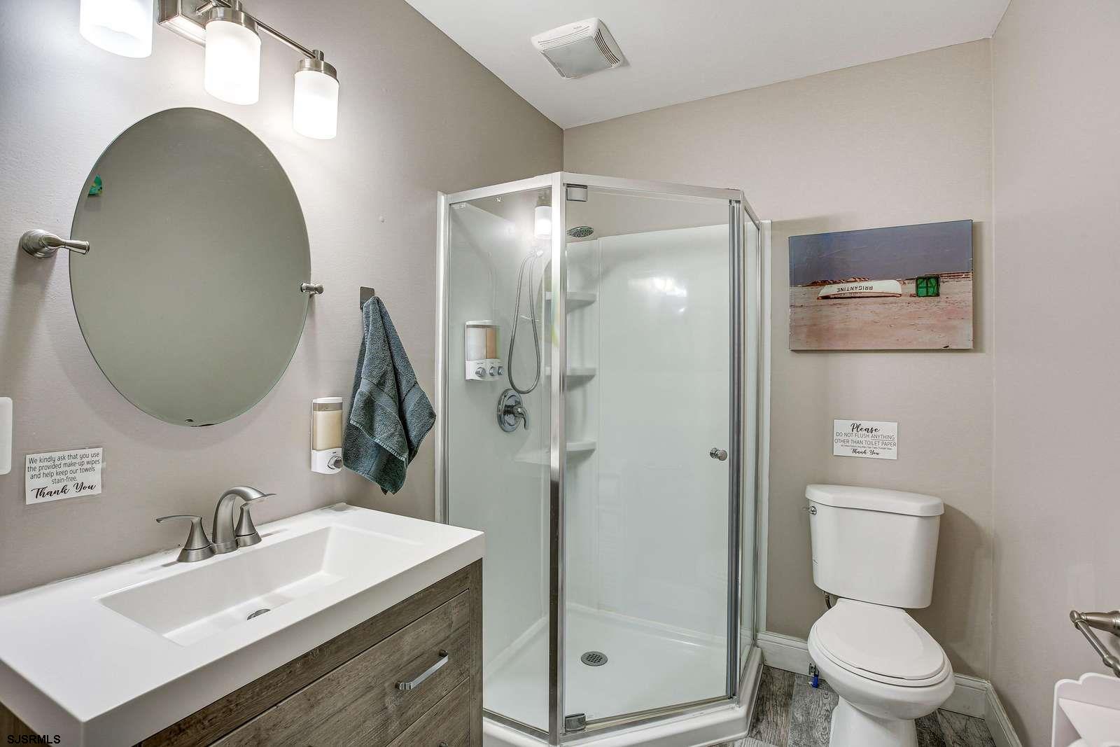 210 34th Street South, Unit 2 Brigantine, NJ 08203 - Photo 8 of 32 a bathroom with a sink toilet and shower