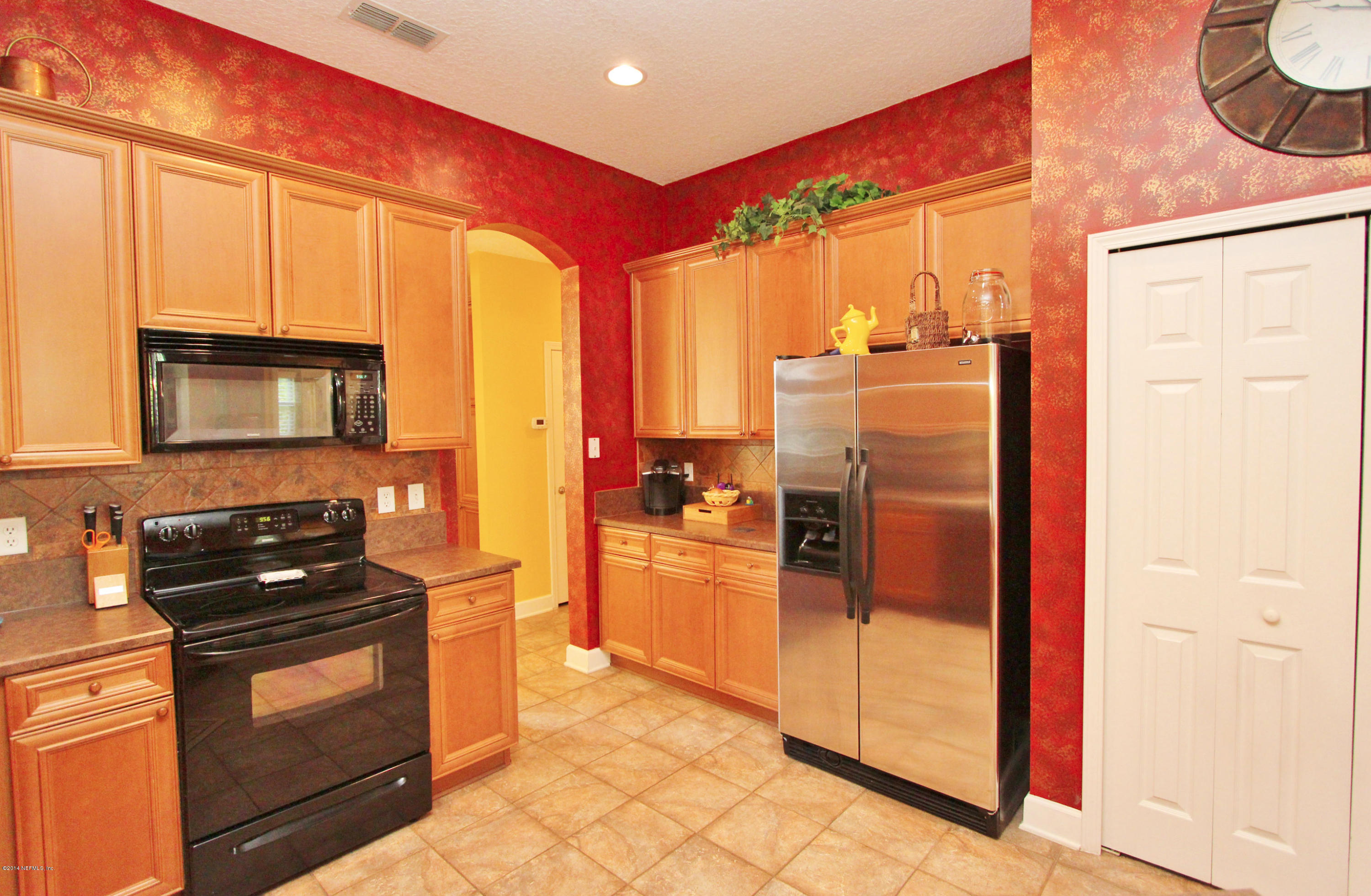 2001 River's Own Road St. Augustine, FL 32092 - Photo 18 of 55 a kitchen with a refrigerator and a stove top oven