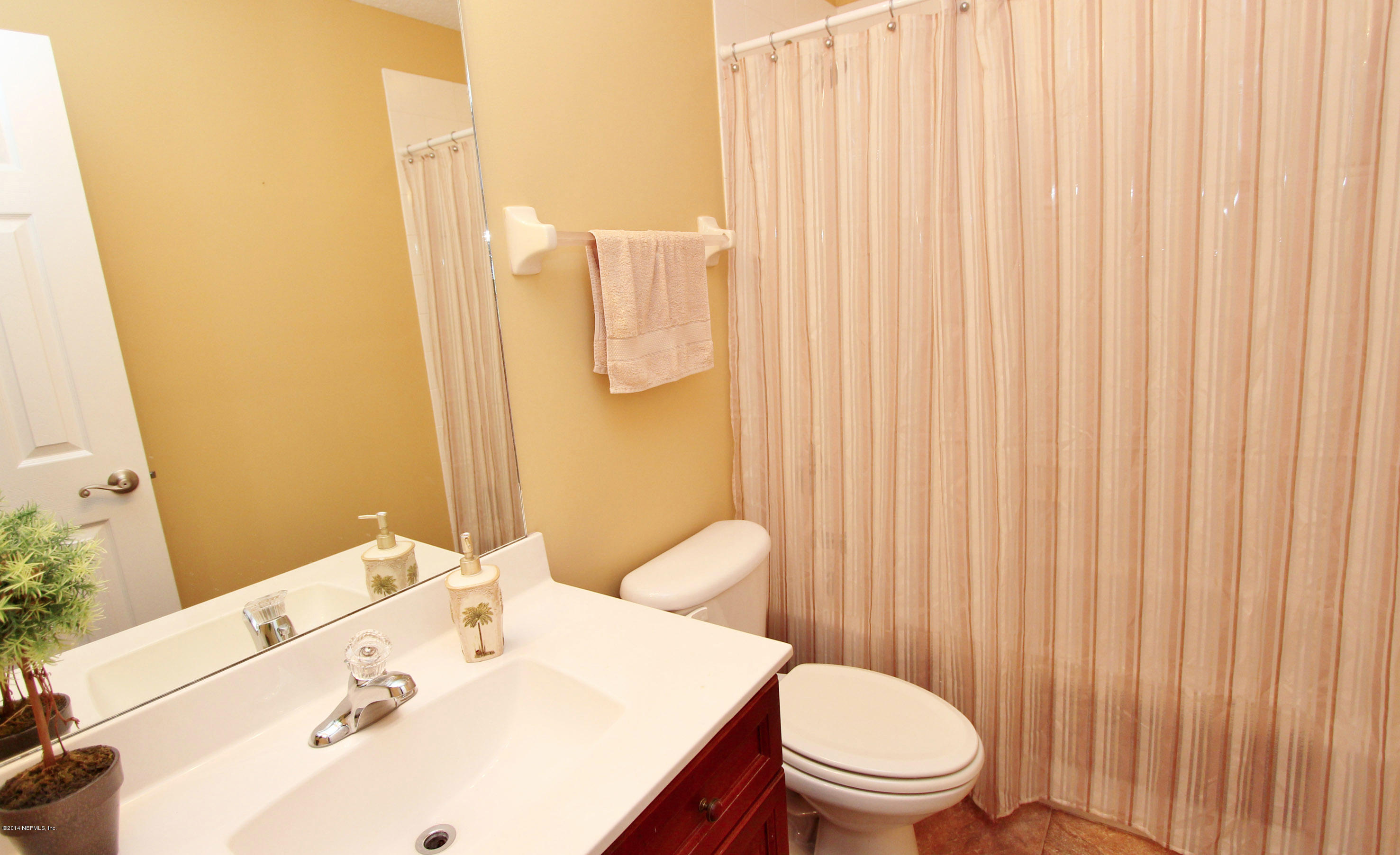 2001 River's Own Road St. Augustine, FL 32092 - Photo 28 of 55 a bathroom with a sink a toilet and shower curtain